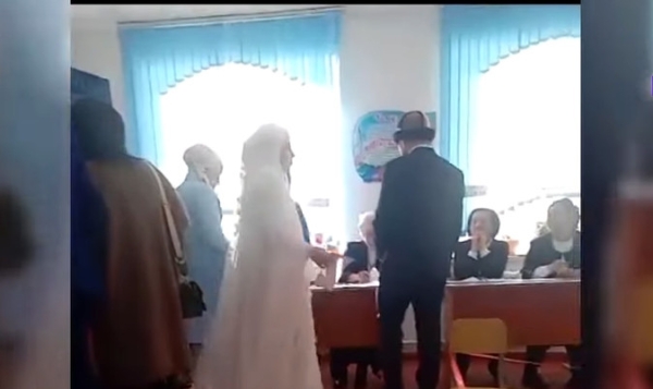 Bride in wedding dress votes in Uzgen district on election day